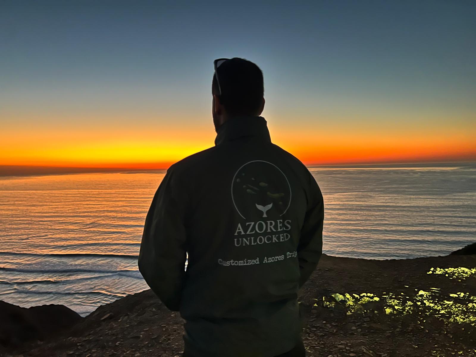 Fabio wearing his Azores Unlocked jacket at sunset